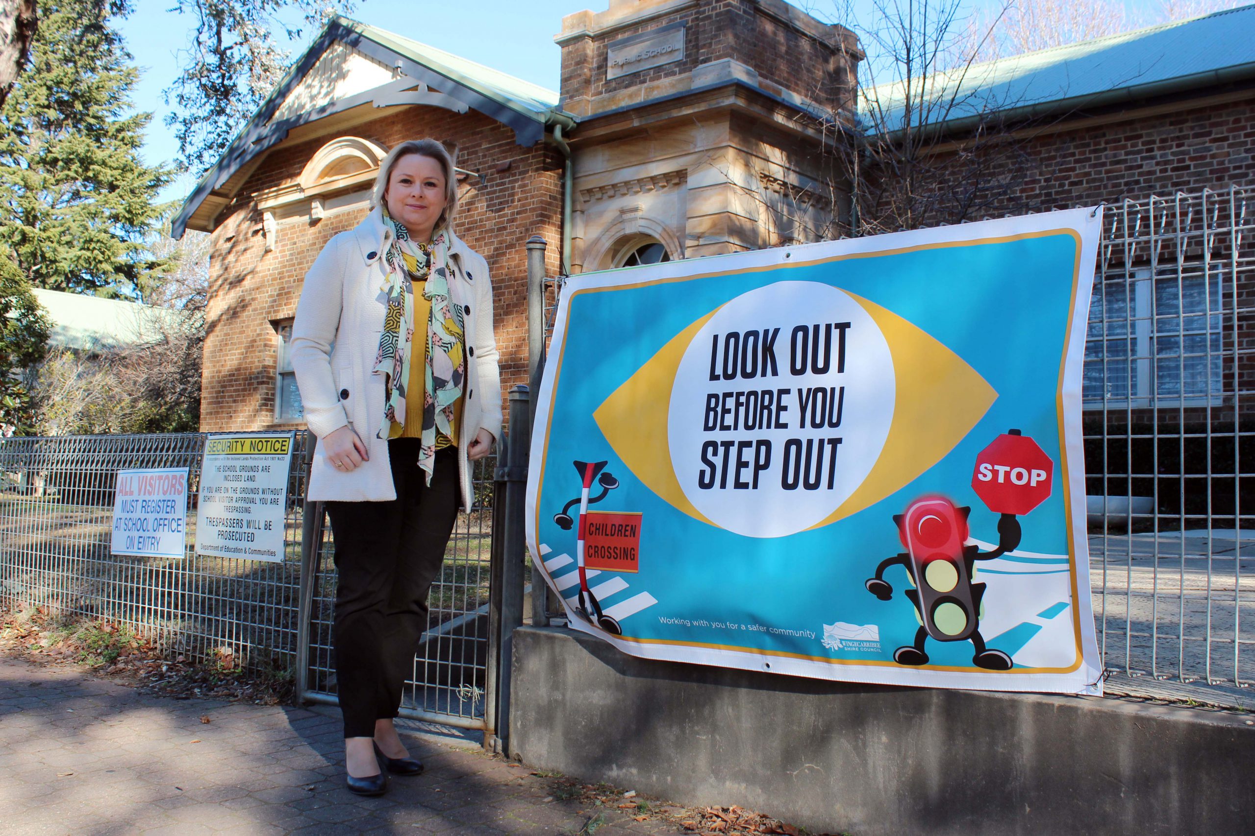 Road Safety Officer, Melanie Lausz, with the custom ‘Look out before you step out’ banner at Bowral Public School