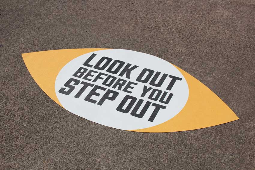 Look before you step out stencil on pavement