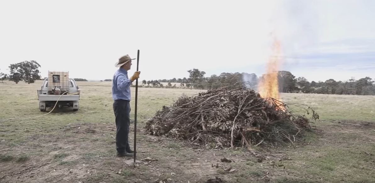 Farmer and pile burn in rural setting