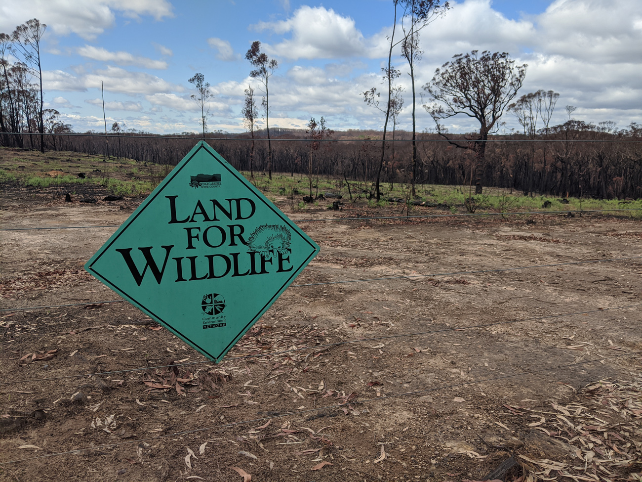 Land for Wildlife sign and burnt landscape