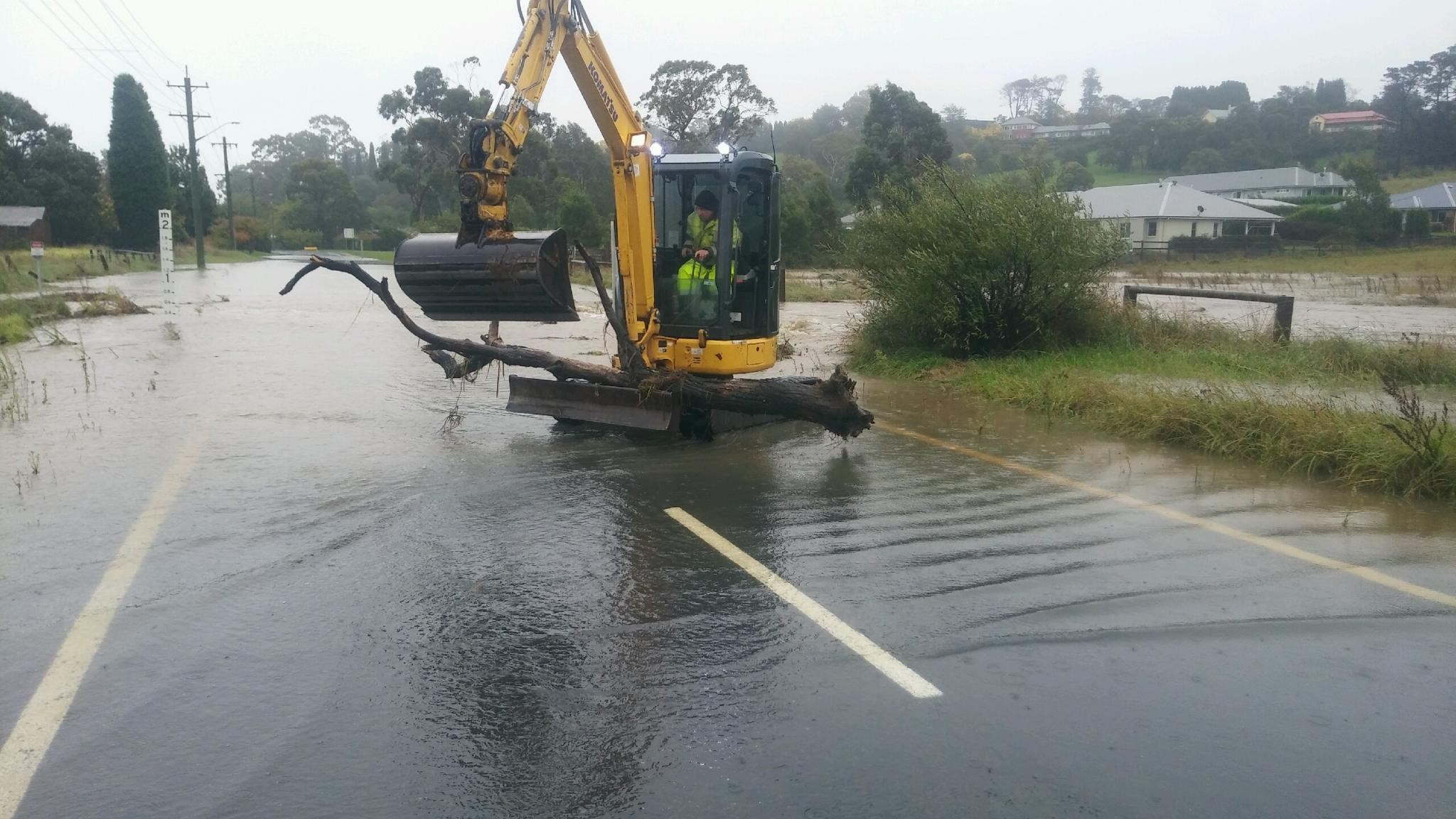Machinery scooping up flood water