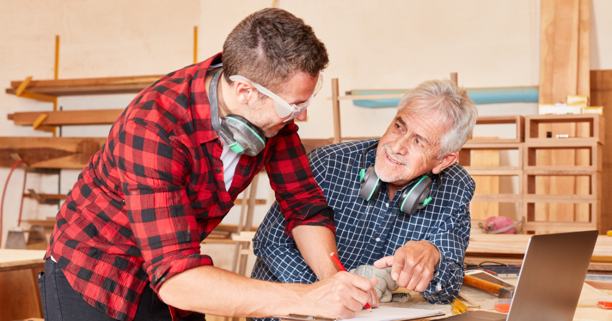 Two men looking at woodworking plans