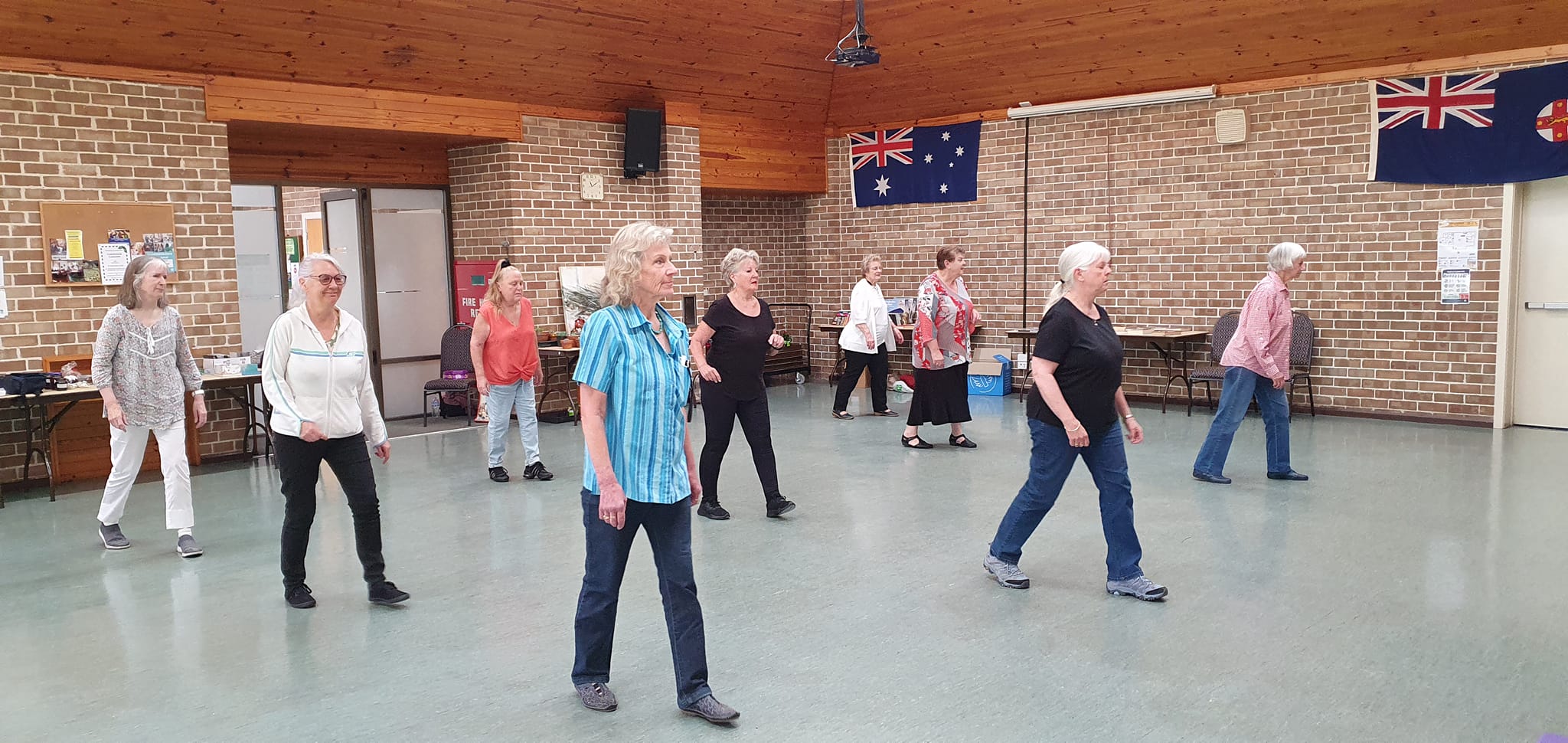 Group of older people dancing in community hall