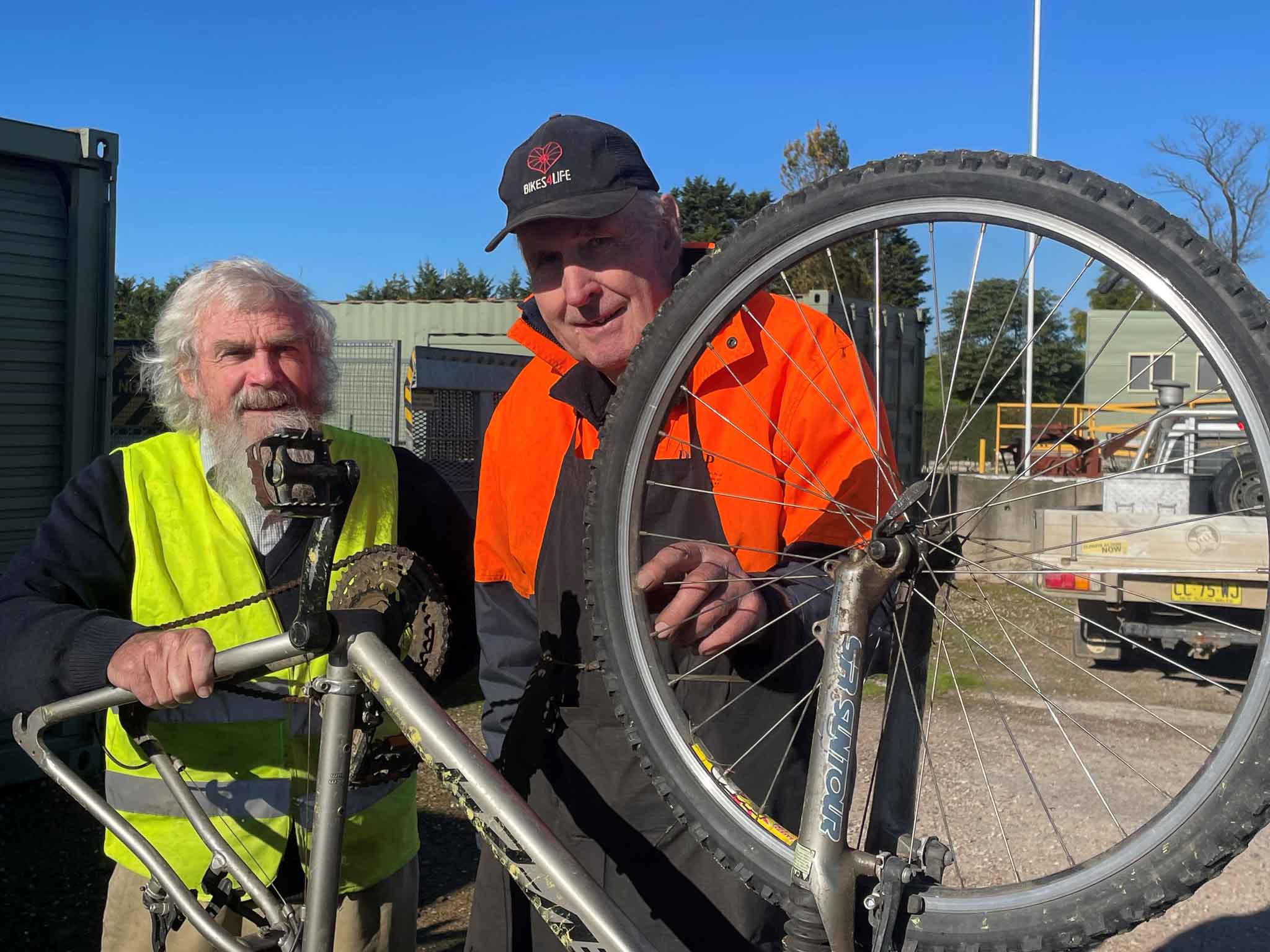 Two men repairing a bike