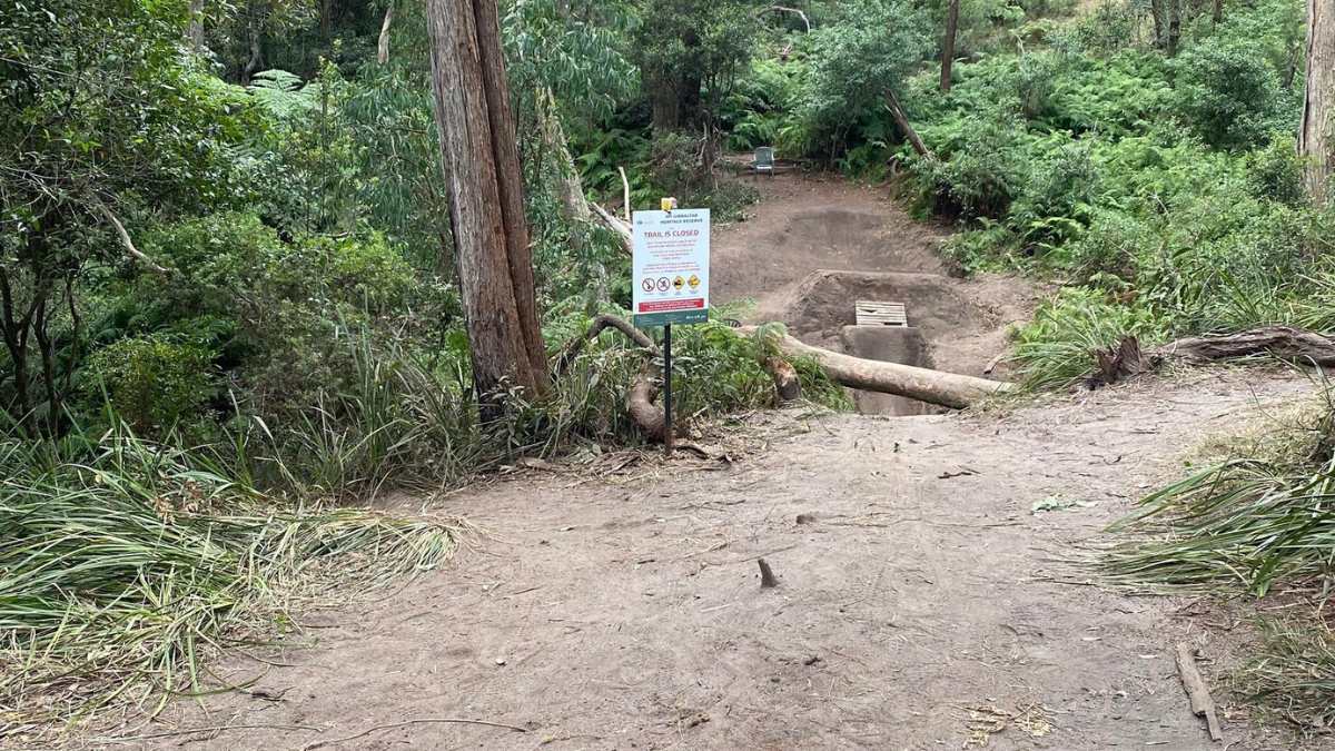 Picture of one of the trails with a sign on it.