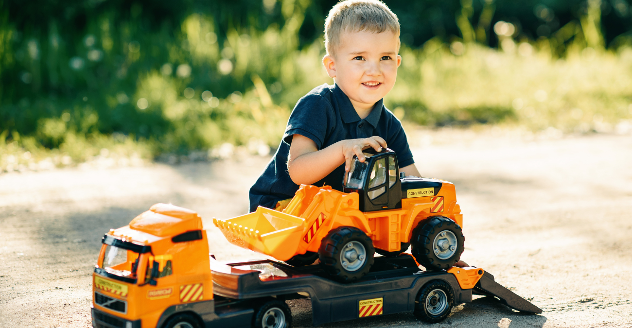 Toddler playing with toy truck